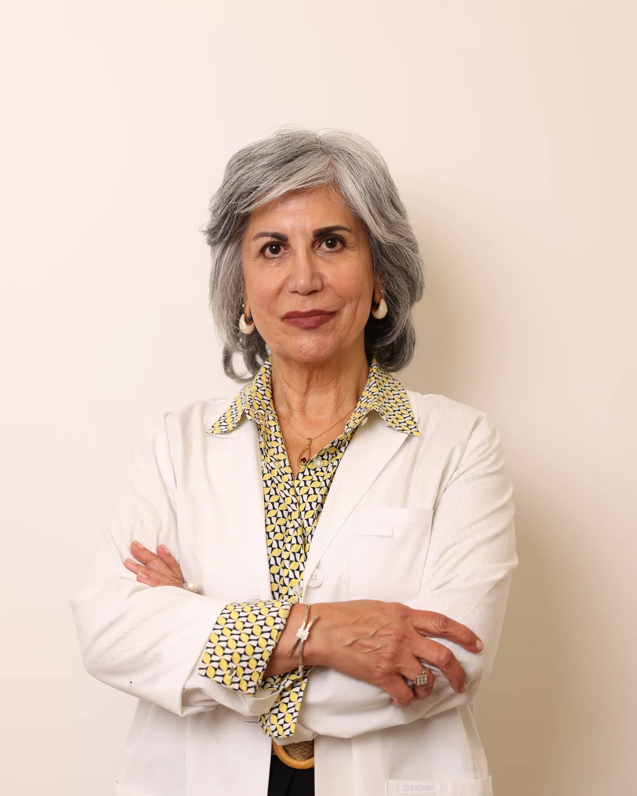 Dr. Roxanna Gangi, Optometrist in York Region, wearing a white coat at her eye clinic